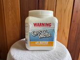 A plastic container labeled 'CRYSTAL WATeR pH Buffer' for pool and spa maintenance.